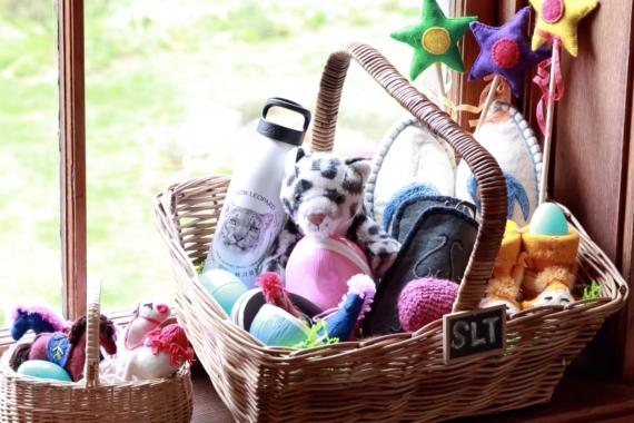 A selection of Snow Leopard Enterprises handicrafts in a wicker-basket