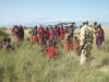 Members of the Maasai communities are employed as community scouts and are gathered around.